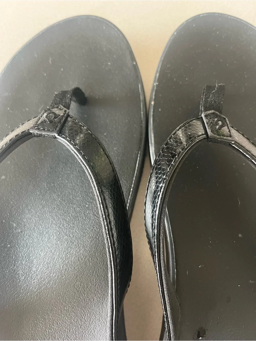 Olukai black flip flops.